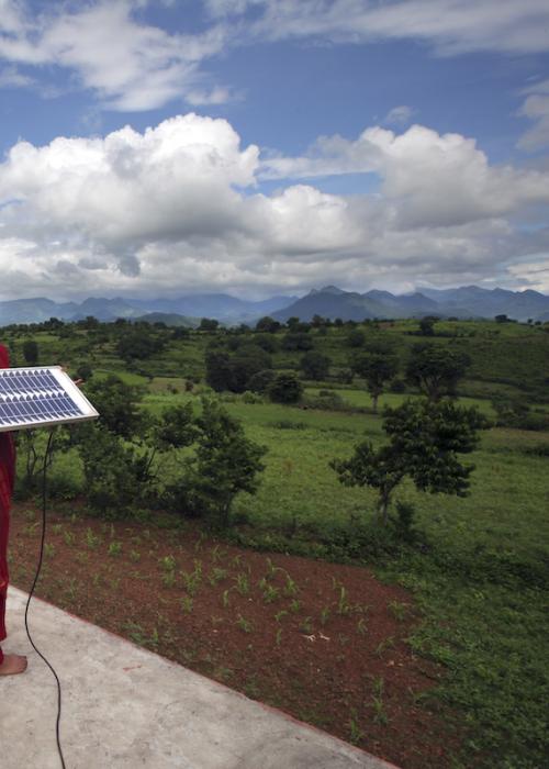 Girl stands with solar panel