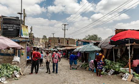 Sellers sell fresh produce on the side of the street in Mathare, an informal community in Nairobi, Kenya.
