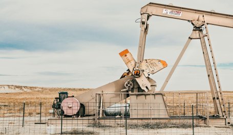 An abandoned oil rig in the middle of a desert. 