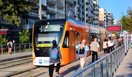 People board a tram in Antalya, Turkey.
