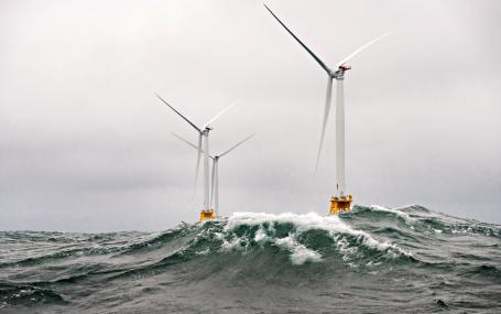 Wind turbines amid heavy seas off the coast of Rhode Island.