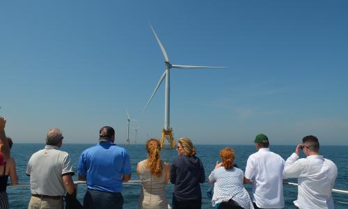 People look out at the Block Island Wind Farm off the coast of Rhode Island.