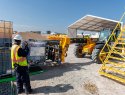 A man directs heavy equipment as part of Charm Industrial's bio-oil production.