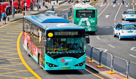 An electric bus drives down a street.