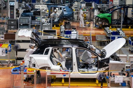 Workers assemble an electric vehicle 