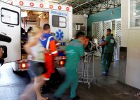 People rush from an ambulance into a hopsital.