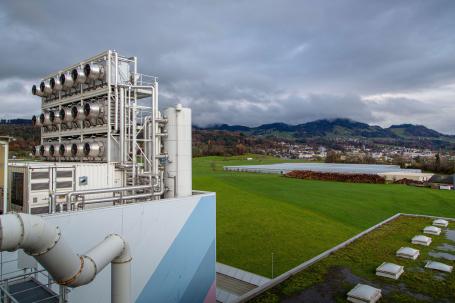 Direct air capture fans on top of a building overlooking green grass in Zurich, Switzerland.