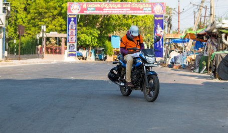 Person riding motorcycle in India during coronavirus pandemic