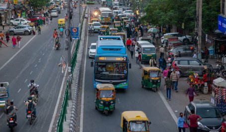 Electric bus on a crowded street in New Delhi, India