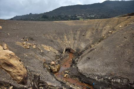 A dry reservoir with just a trickle of water at the bottom.