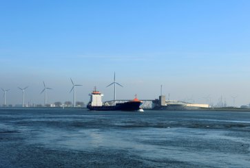 A ship passes by wind turbines in Rotterdam, Netherlands.