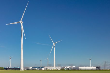 Large wind turbines rise above data centers in Eemshaven, The Netherlands.