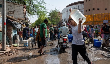 A woman carries water during a blistering hot day in New Delhi, India.