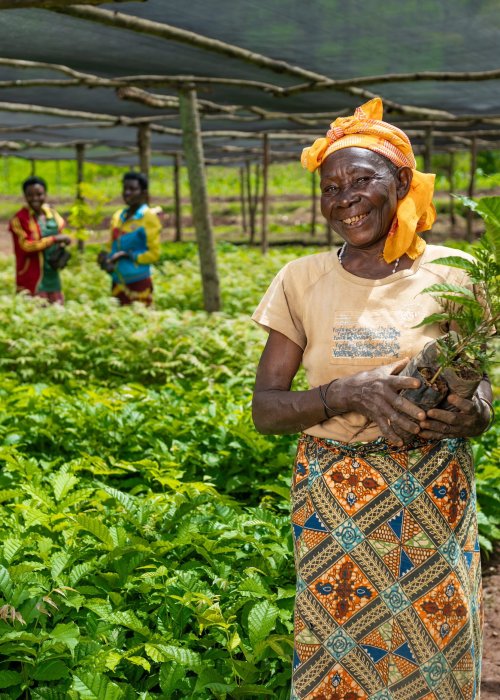Ines Ruhengeri, WRI Restore Local partner, with a tree