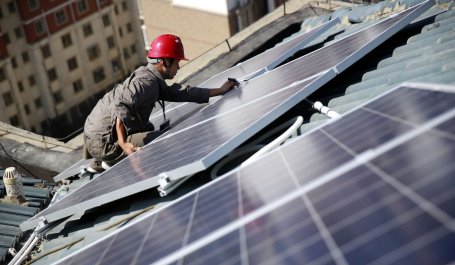 Man installing solar panels in Jiangxi, China.