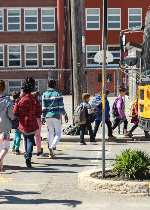 Children board school bus
