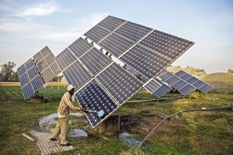 Farm workers clean the solar panels of a solar water pump at the farms of Gurinder Singh a farmer with a land holding of 80 acres in Jagadhri, Haryana state, India.&nbsp;  Photo by Prashanth Vishwanathan (IWMI)&nbsp;