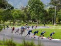 A group of people rollerblade on a pathway in Loja, Ecuador.