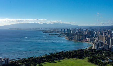 An ocean next to a cityscape. 