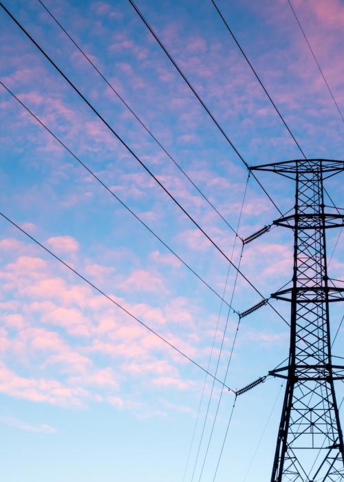 Power line against sky with pink clouds.