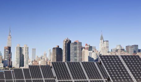 Roof top solar installation with Midtown Manhattan view as background.