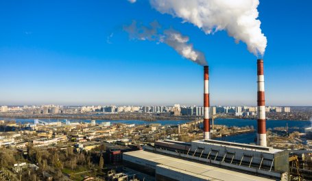 A smokestack of a garbage incineration plant against the backdrop of the city