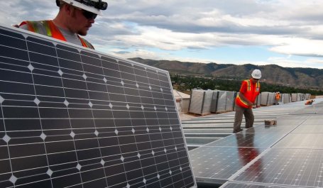 two men installing solar panels