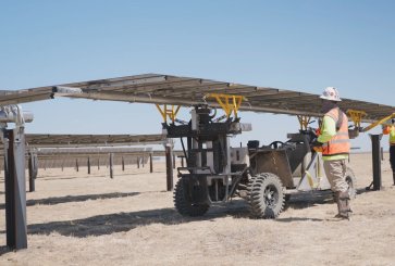 Workers install solar panels at a Texas solar field