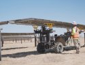 Workers install solar panels at a Texas solar field