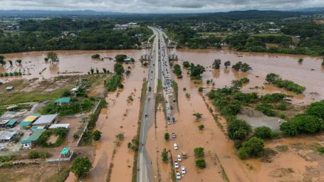 Cars on a partially submerged highway after a flood.