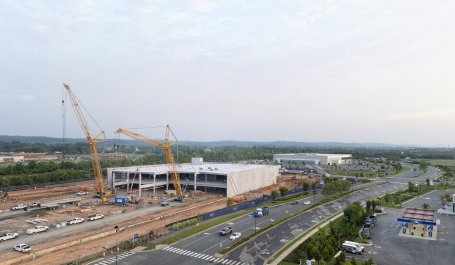 Yellow cranes rise above a data center being constructed in Virginia.