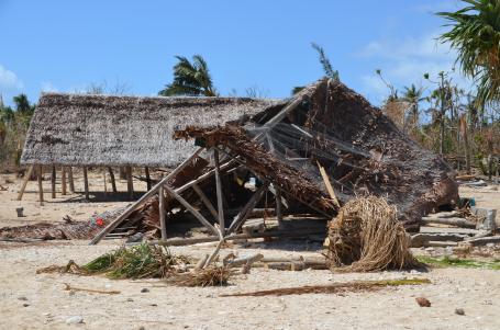 Housing structures severely damaged from cyclones on the beach in Vanuatu.