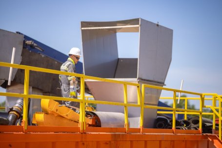 A worker at Vaulted Deep's Great Plain facility inspects equipment.