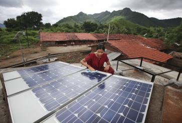 Woman washing solar panels.