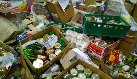 Boxes of canned goods and other products discarded at a supermarket.