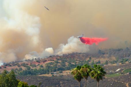 A plane drops a fire retardant to battle flames in Southern California.