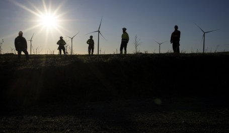 Workers check that the wind turbines are working properly at Aurora Wind Farm.