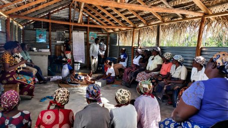 Women sit in a circle during a finance workshop.