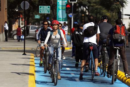 Multiple cyclists biking on cycle track in Santiago