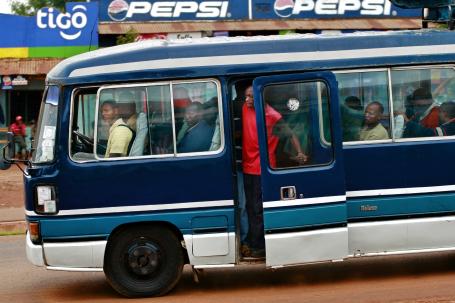 Riders on a public transit bus in a busy African city